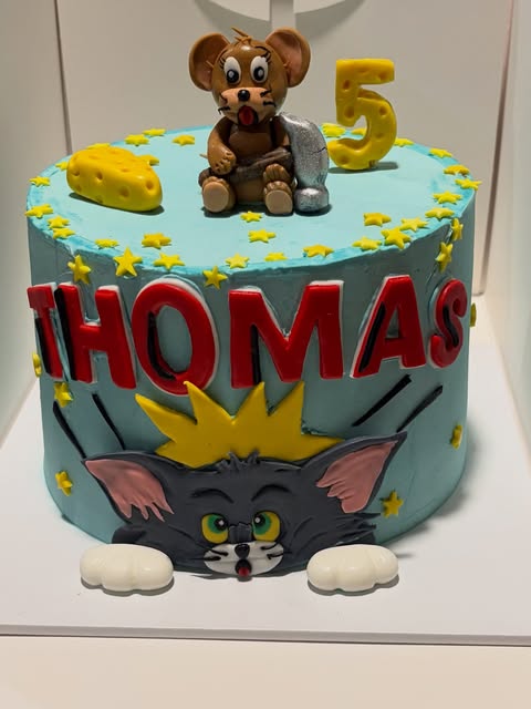 Lovelybakes turquoise birthday cake with a handmade mouse character and yellow stars